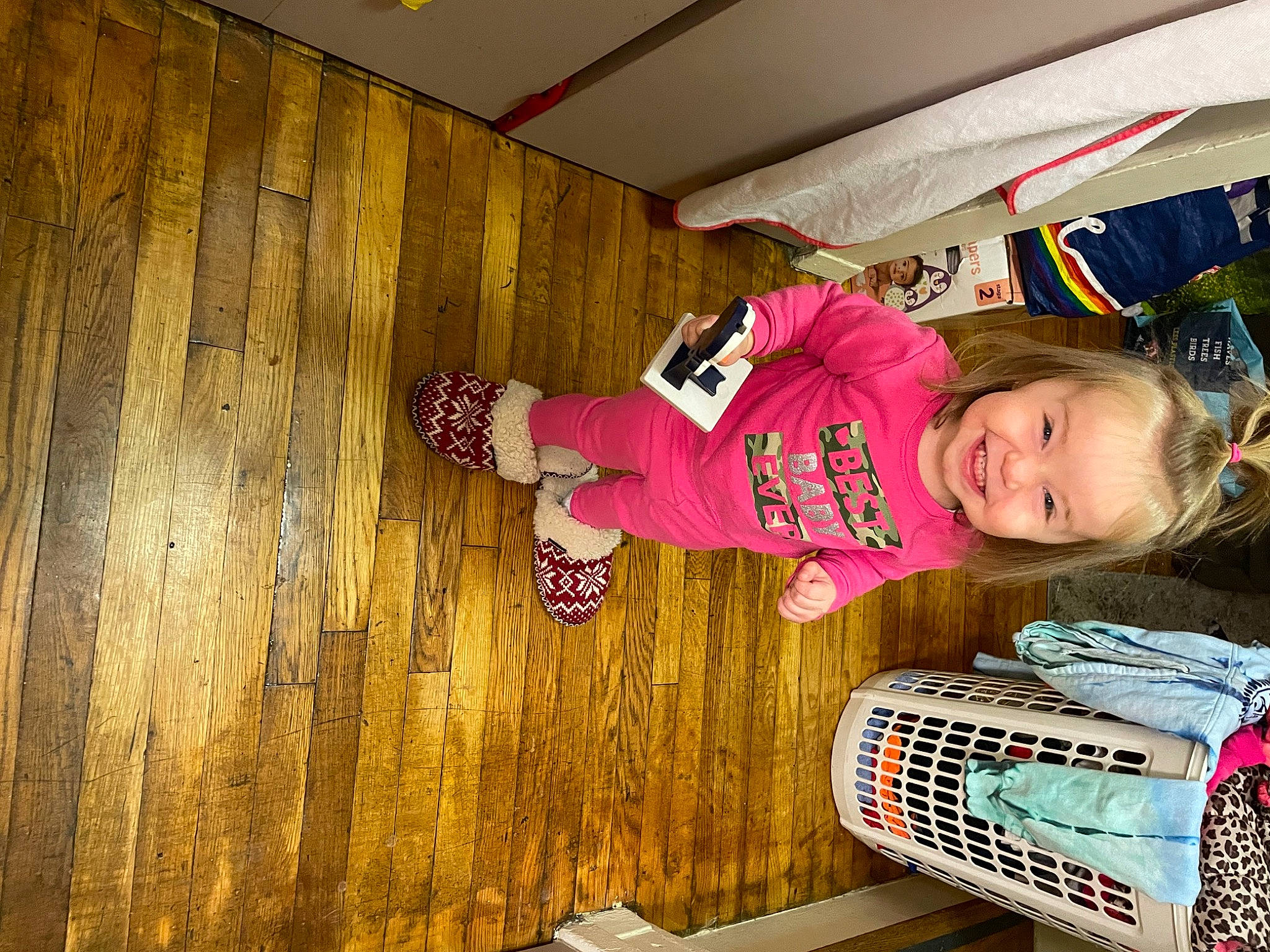 Laylah is registered to the contest to win money with this photo: baby, baby_toddler_clothing, child, design, flooring, fun, happy, hardwood, head, joy, leisure, magenta, pattern, person, play, room, sitting, smile, sneakers, toddler