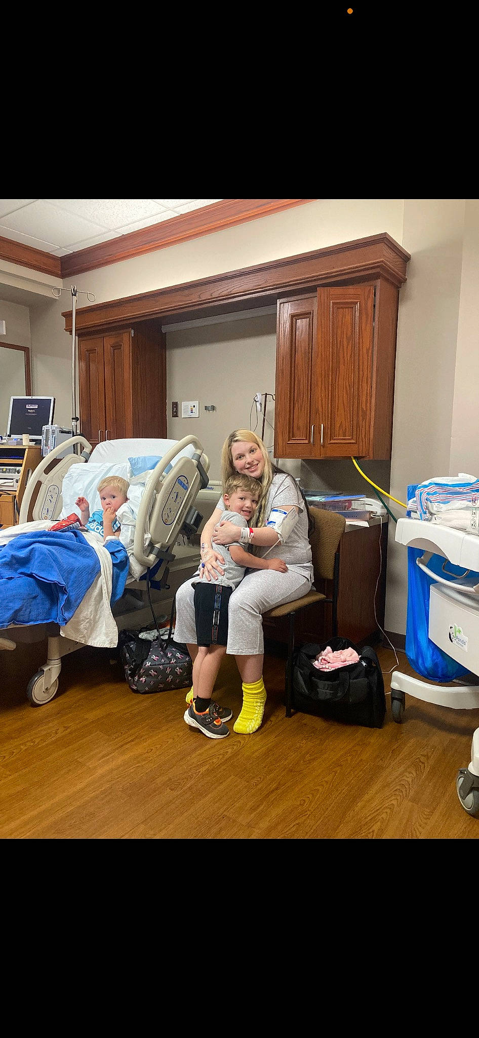 Greyson is registered to the contest to win money with this photo: backpack, bag, blue, cabinetry, chest_of_drawers, comfort, cupboard, door, drawer, event, floor, flooring, fun, hardwood, joy, leisure, luggage_and_bags, person, room, sitting