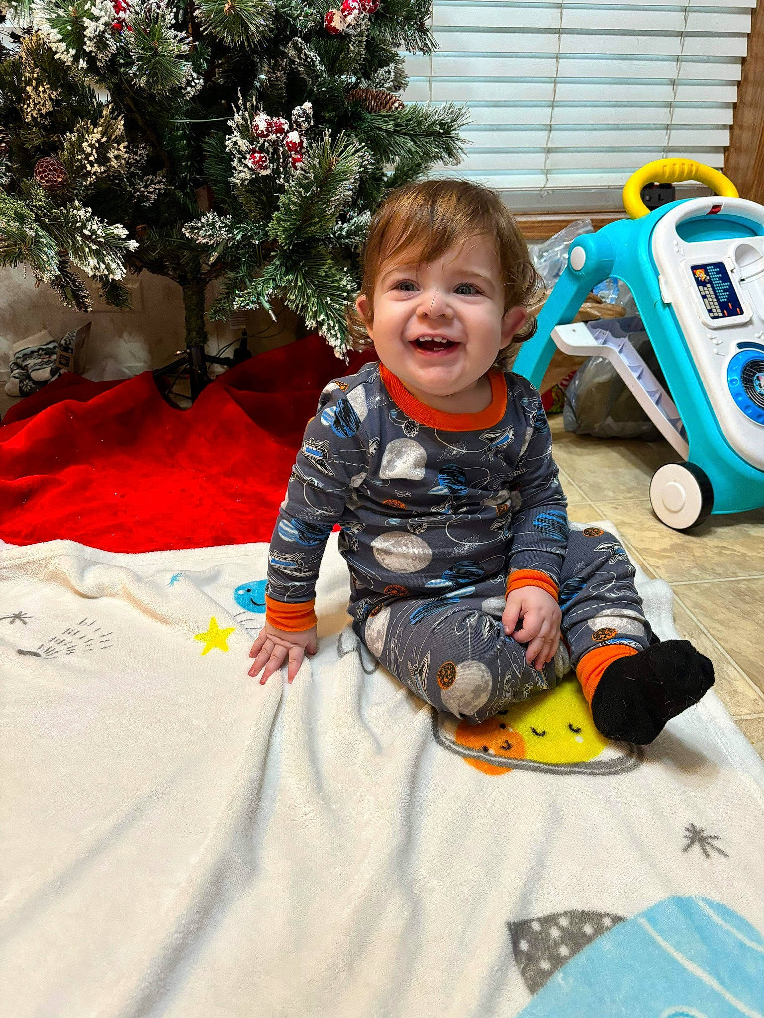 Tommie joined the competition — help win amazing prizes! child, christmas_ornament, conifer, event, fun, grass, happy, holiday, joy, leisure, person, play, recreation, riding_toy, sitting, smile, toddler, toy, toy_vehicle, tree