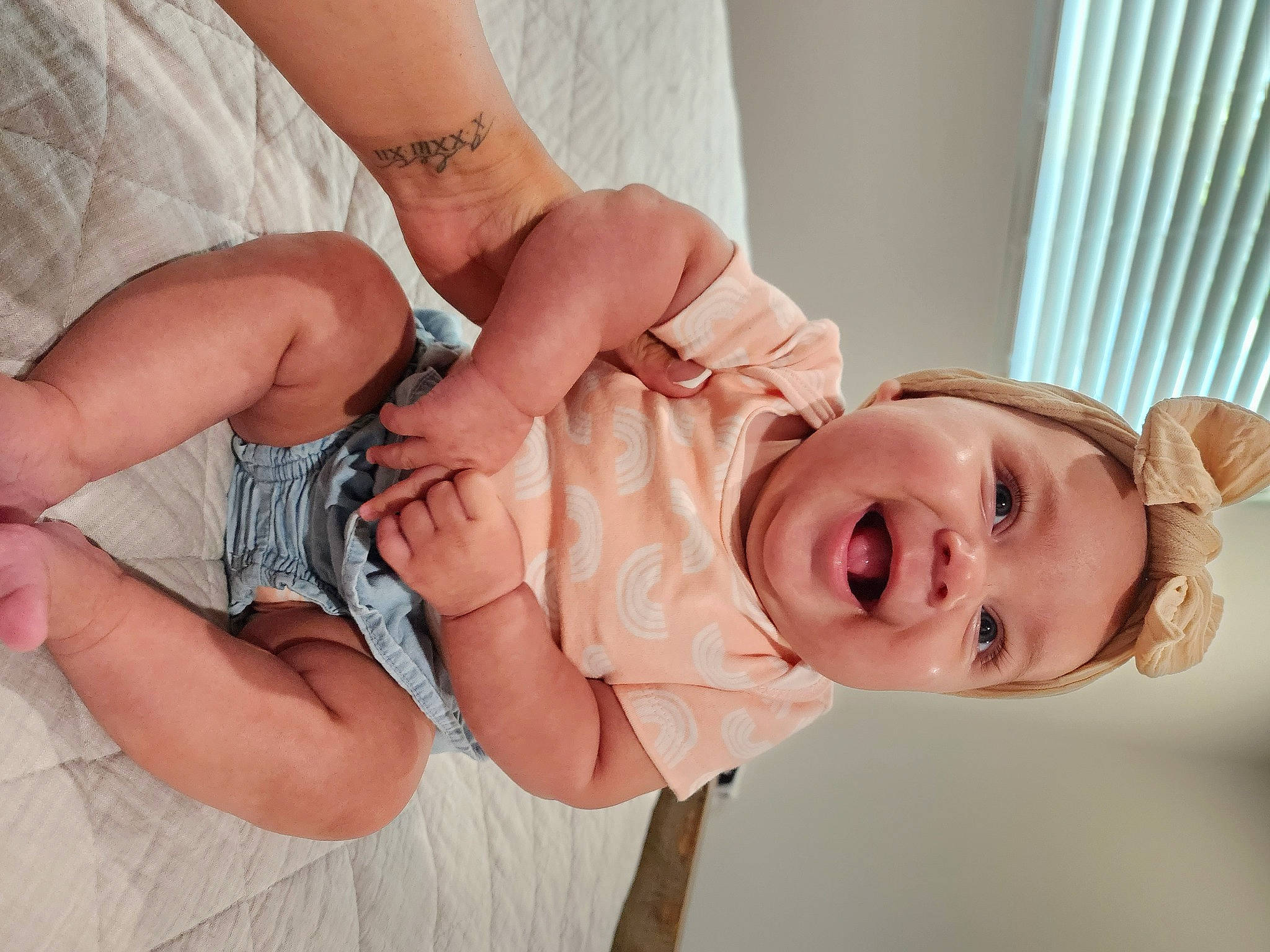 Amari is registered to the contest to win money with this photo: arm, baby, baby_toddler_clothing, comfort, dress, finger, gesture, hand, happy, human_body, leg, mouth, nail, neck, person, skin, sleeve, smile, stomach, thumb
