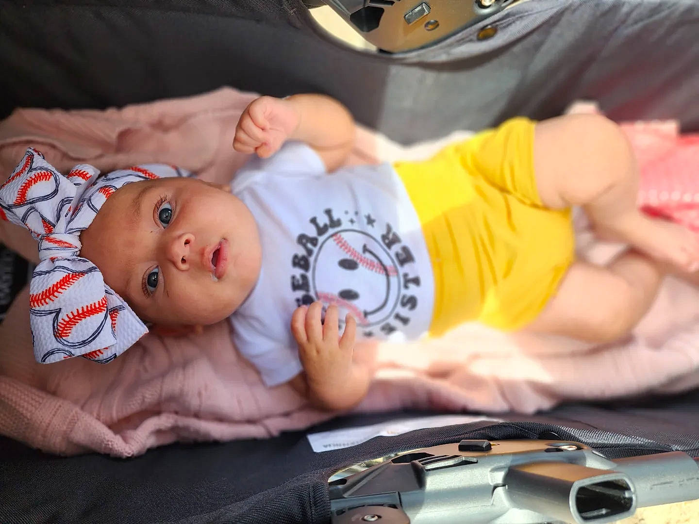 Amari is registered to the contest to win money with this photo: baby, baby_products, baby_toddler_clothing, cheek, child, comfort, finger, hand, hat, headwear, mouth, nail, person, product, room, sitting, skin, sleeve, t_shirt, thumb