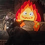 cat, kitten, fireplace, felt, flame, toy, wood, brick_wall, black_cat, indoor, pet, animal, curious, cozy, warm_light, decor, cute, sitting, whimsical, face