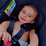 baby, black, car_seat, child, child_safety, closeup, cute, diaper, eyes, face, hand, happy, harness, indoor, infant, person, safety, seatbelt, smiling, toy