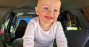 Theodore is registered to the contest to win money with this photo: baby, blanket, candid, car, casual, child, cute, daylight, grip, hands, happy, interior, portrait, seat, smiling, toddler, tongue, vehicle, white_shirt, window