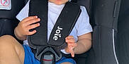 Cohen joined the competition — help win amazing prizes! toddler, child, car_seat, blue_eyes, curly_hair, white_tshirt, blue_shorts, sitting, safety_harness, footwear, indoor, seatbelt, car_interior, person, young_child, cute, expression, baby_shoes, seat, curious