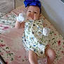 Peyton joined the competition — help win amazing prizes! baby, blanket, blue_bow, child, cozy, cute, floral_onesie, floral_pattern, headband, indoor, infant, lying_down, mittens, person, pink, playful, playpen, quilt, soft_lighting, young