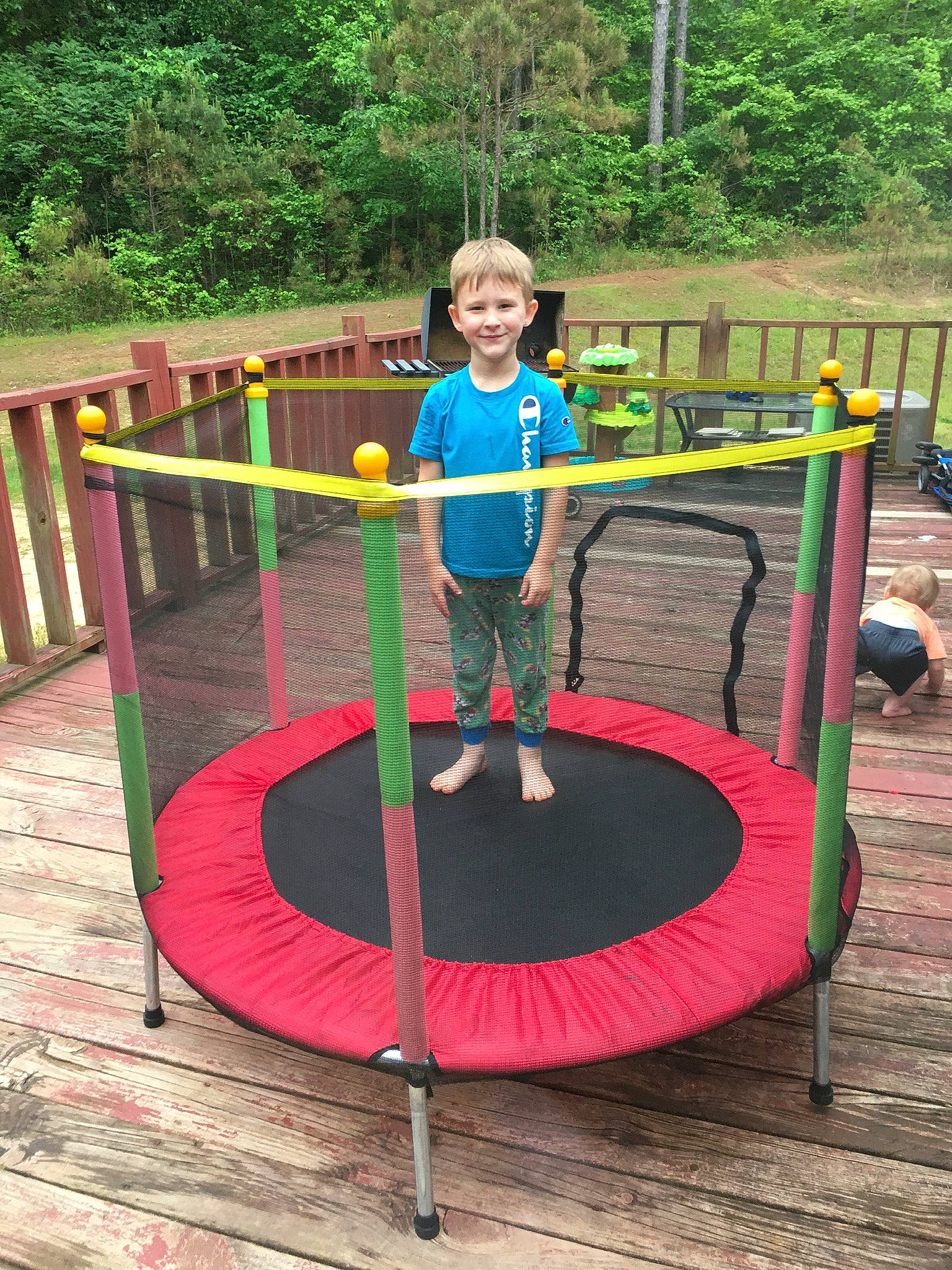 Braxtyn is registered to the contest to win money with this photo: balance, city, electric_blue, footwear, fun, grass, joy, leisure, nonbuilding_structure, outdoor_play_equipment, outdoor_recreation, person, plant, play, playground, recreation, shorts, smile, t_shirt, toddler