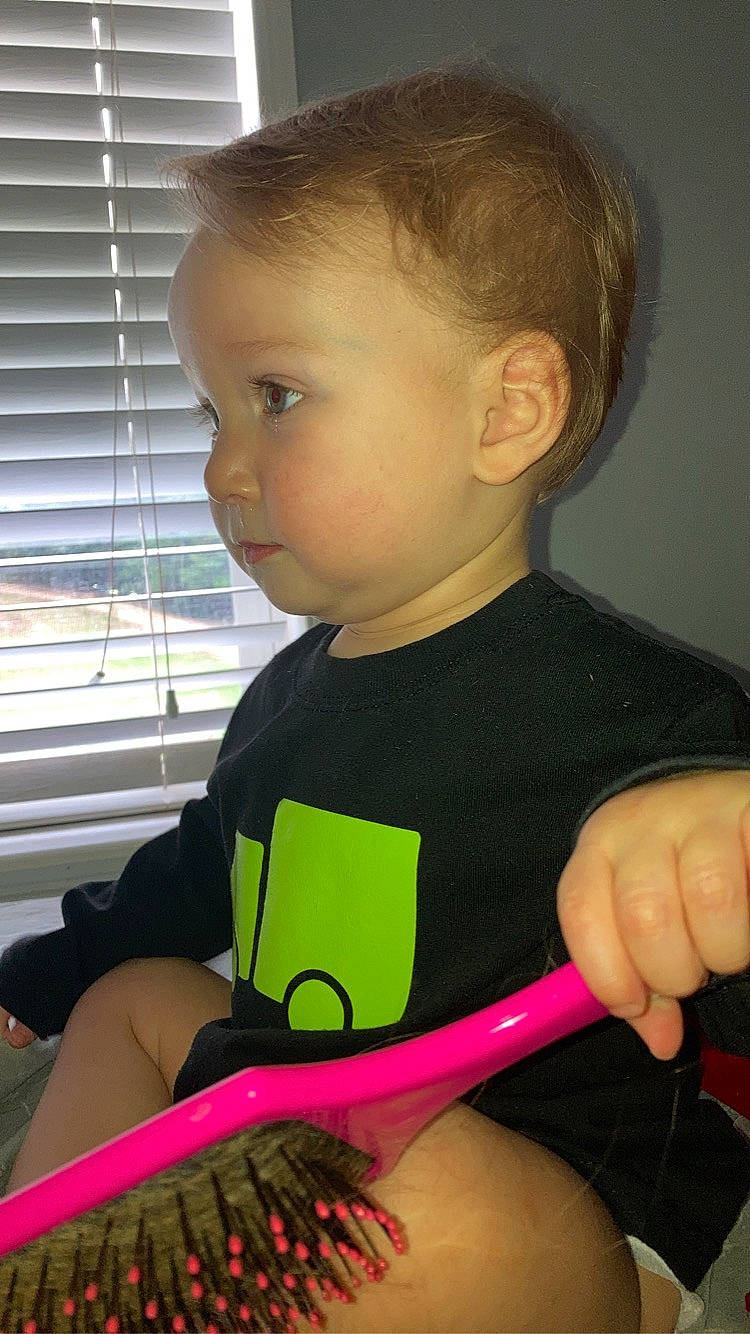 Bentley is registered to the contest to win money with this photo: baby, baby_toddler_clothing, chair, child, finger, guitar_accessory, hand, human_body, musical_instrument, musical_instrument_accessory, neck, person, plucked_string_instruments, room, sitting, string_instrument, string_instrument_accessory, t_shirt, toddler, window