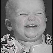 Ava-Rae is registered to the contest to win money with this photo: baby, smiling, black_and_white, closeup, child, happy, face, hand, furniture, patterned_clothing, tooth, infant, cute, portrait, indoor, young, expression, joy, person, holding