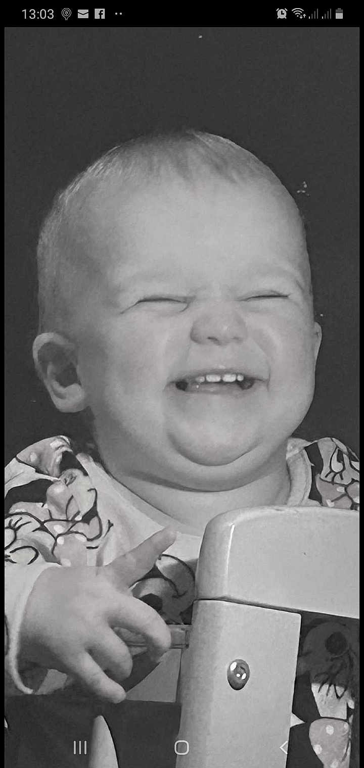 Ava-Rae is registered to the contest to win money with this photo: baby, smiling, black_and_white, closeup, child, happy, face, hand, furniture, patterned_clothing, tooth, infant, cute, portrait, indoor, young, expression, joy, person, holding