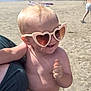 Albert is registered to the contest to win money with this photo: baby, sunglasses, beach, child, smile, sand, summer, sunny, person, ocean, shore, toddler, clothing, hand, adult, vacation, outdoor, sunlight, fun, happy