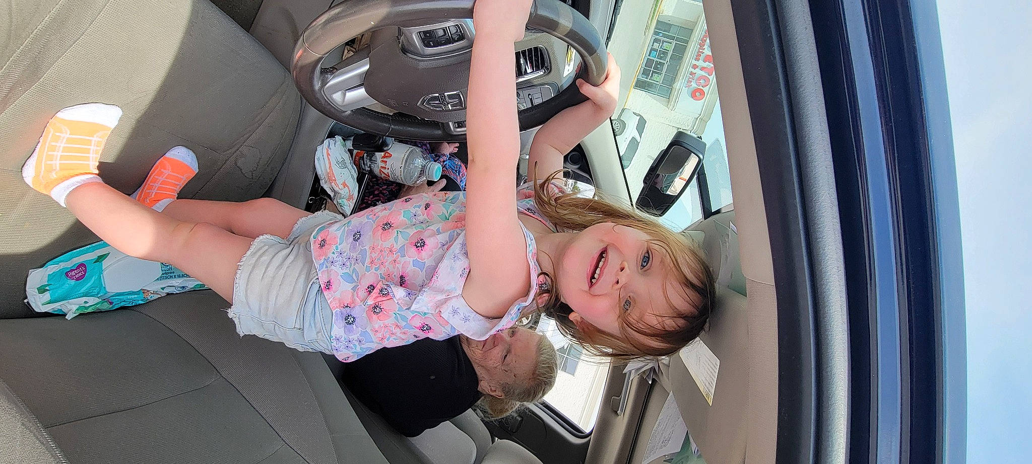 Caroline is registered to the contest to win money with this photo: auto_part, automotive_design, automotive_exterior, automotive_lighting, automotive_tire, car, car_seat, child, family_car, fun, human_leg, joy, motor_vehicle, person, personal_luxury_car, steering_wheel, thigh, tire, toddler, vehicle