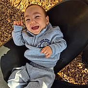 Matthew joined the competition — help win amazing prizes! baby, child, smiling, laughing, swing, playground, wood_chips, gray_clothing, hoodie, sweatpants, outdoor, sunlight, happy, person, infant, seat, joyful, casual_clothing, play, fun