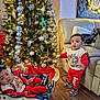 Matthew is registered to the contest to win money with this photo: baby_rocker, child, christmas_tree, couch, cute, decorations, family, festive, flooring, holiday, holiday_season, indoor, joy, lights, living_room, matching_outfits, ornaments, red_clothing, sneakers, toddler