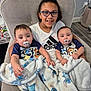 Kiara is registered to the contest to win money with this photo: child, baby, twin_babies, glasses, blanket, armchair, smile, indoor, family, person, pacifier, clothing, floor, wall, home, comfort, cute, happy, portrait, seated