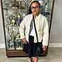 Kiara joined the competition — help win amazing prizes! child, girl, trophy_case, indoor, floor, jacket, skirt, glasses, bag, black_shoes, white_socks, hand_on_hip, smile, portrait, person, fashion, achievement, award, display, casual