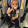 Kaylanna joined the competition — help win amazing prizes! baby, car_seat, pacifier, headband, black_shoes, leggings, sitting, child, infant, safety_harness, indoor, cute, portrait, person, clothing, accessory, bracelet, floor, seat, comfort
