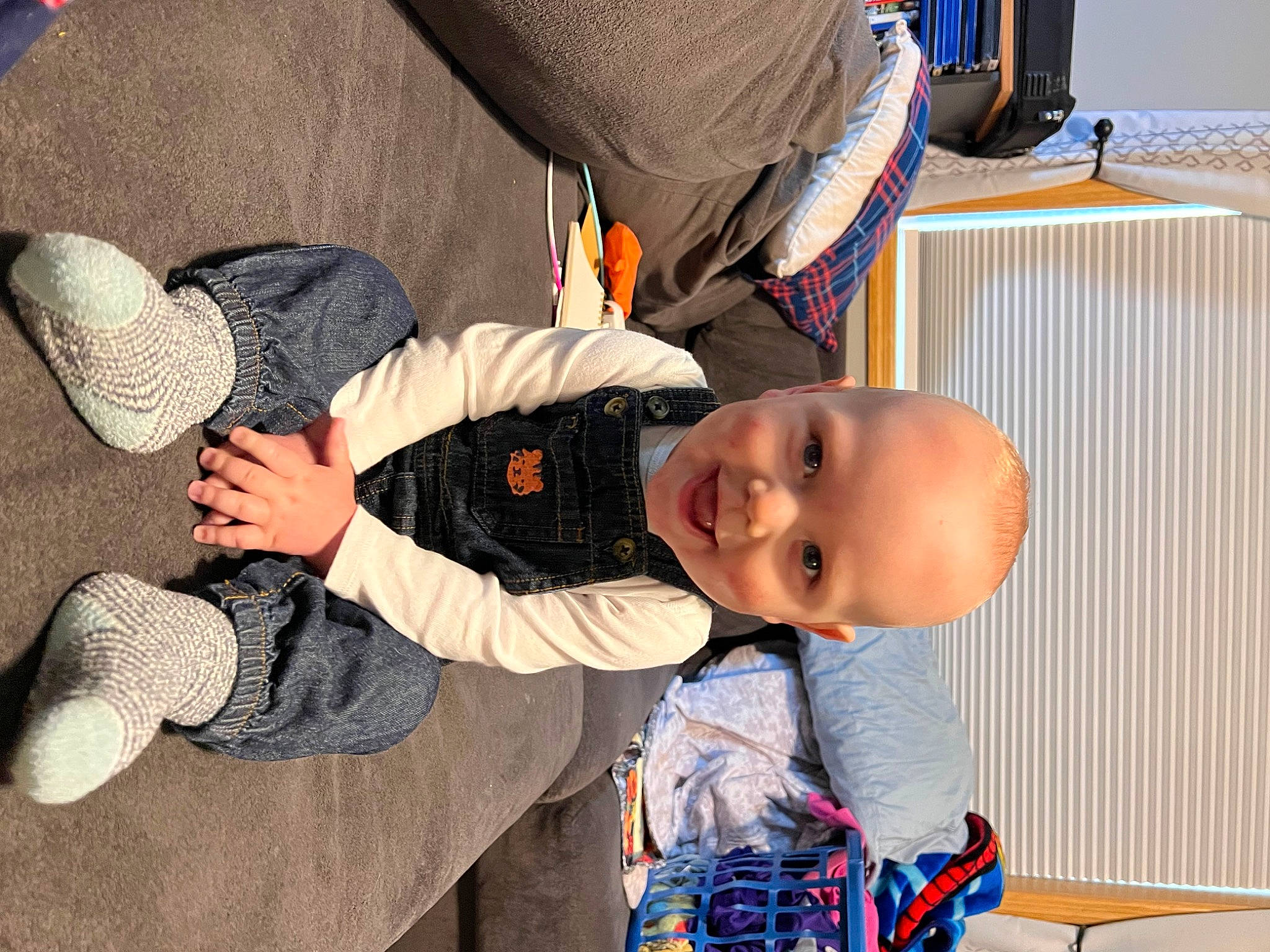 Easton joined the competition — help win amazing prizes! arm, baby, baby_products, baby_toddler_clothing, blue, child, comfort, finger, foot, fun, gesture, happy, human_body, person, room, sitting, skin, smile, sock, thumb