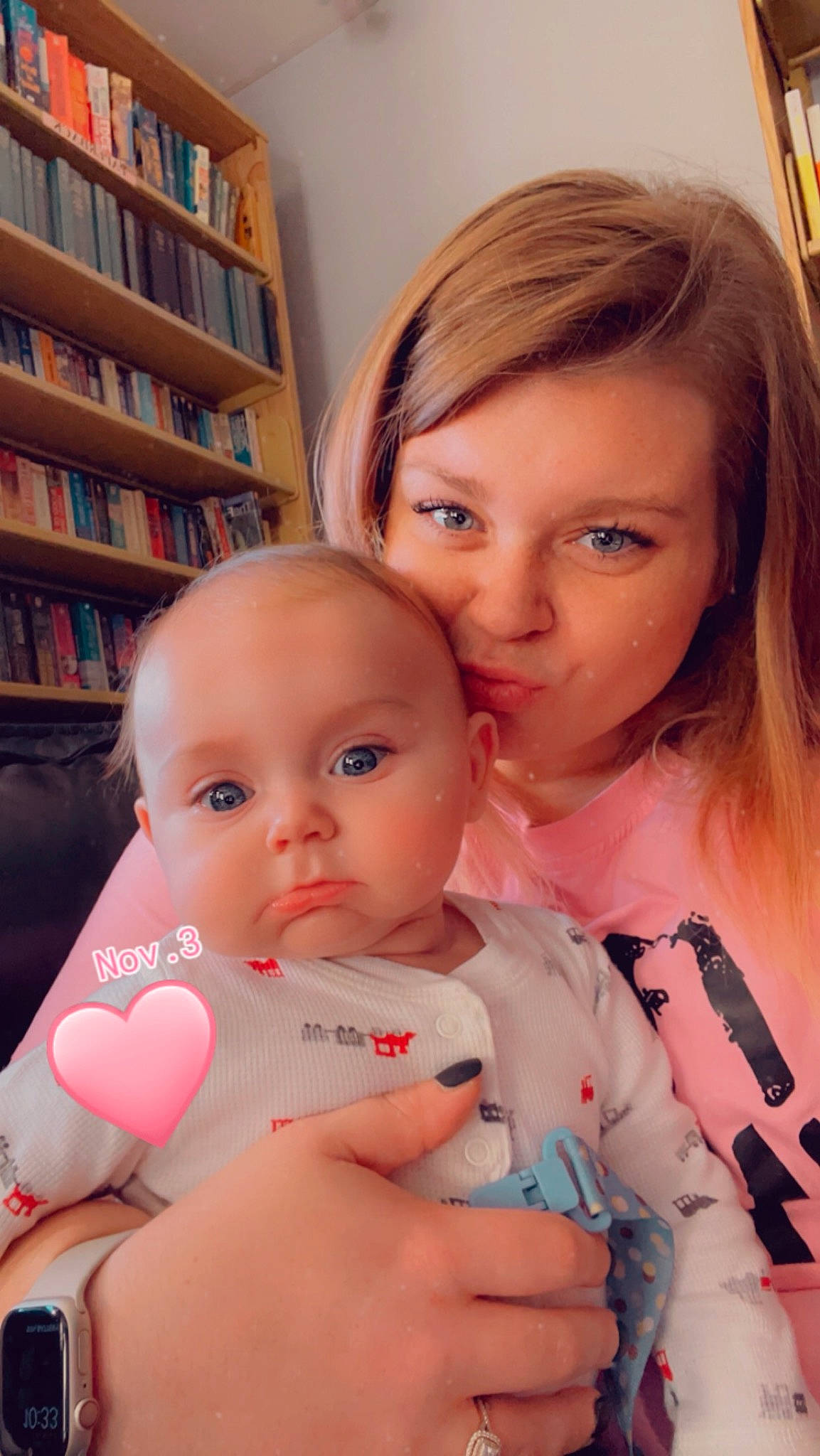 Kingsley joined the competition — help win amazing prizes! baby, baby_toddler_clothing, beauty, bookcase, cheek, chin, eyelash, face, facial_expression, finger, gesture, hand, happy, lip, mouth, nose, person, shelf, skin, thumb