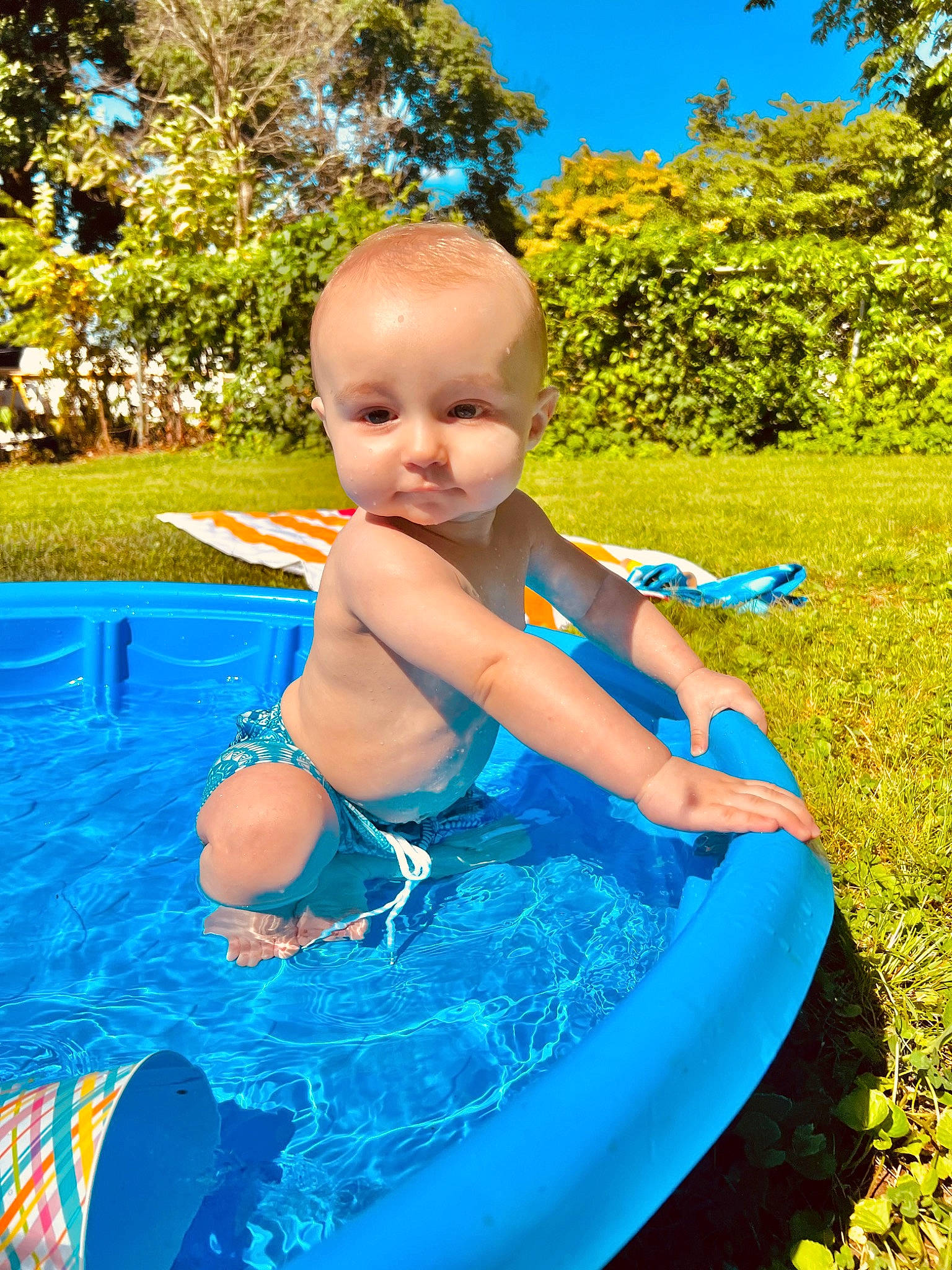 Brayden joined the competition — help win amazing prizes! azure, baby, bathing, blue, child, electric_blue, fun, grass, happy, leisure, people_in_nature, person, plant, recreation, sky, smile, summer, swimwear, toddler, tree