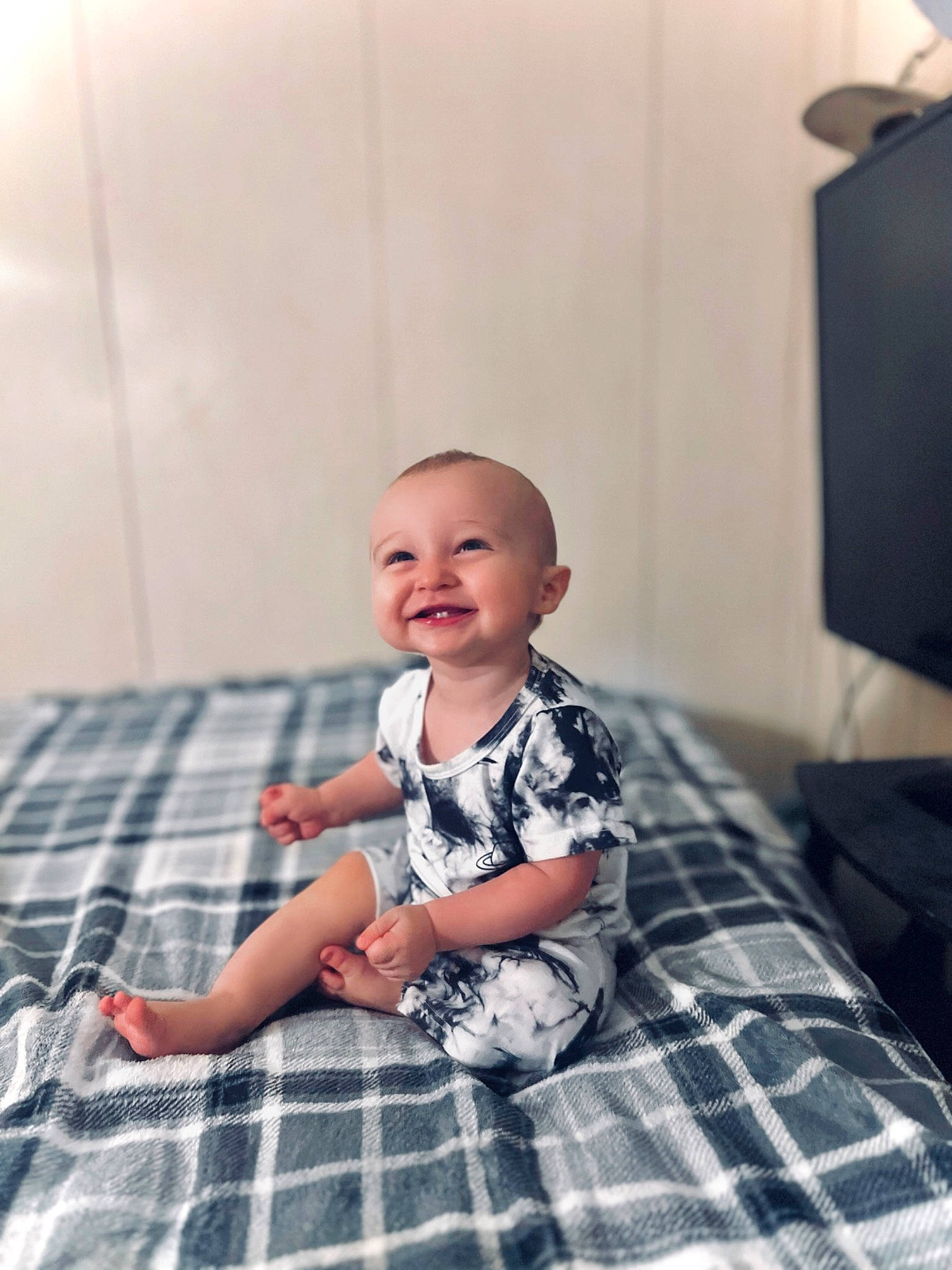 Brayden is registered to the contest to win money with this photo: baby, baby_toddler_clothing, child, comfort, flash_photography, floor, flooring, fun, happy, hardwood, joy, pattern, person, plaid, sleeve, smile, standing, t_shirt, tartan, television