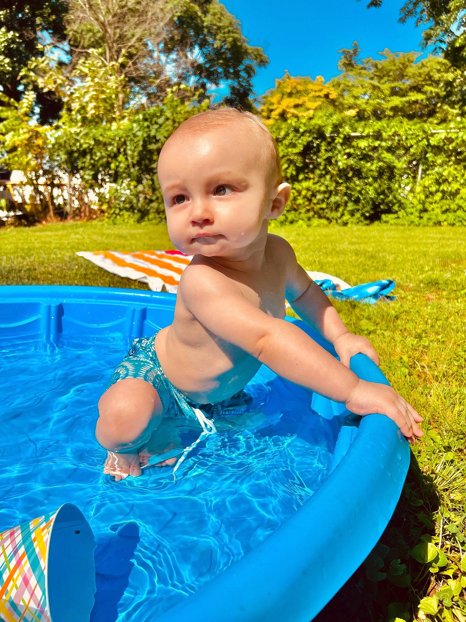 Brayden joined the competition — help win amazing prizes! azure, baby, baby_toddler_clothing, bathing, blue, child, electric_blue, fun, grass, happy, leisure, people_in_nature, person, plant, recreation, sky, smile, swimwear, toddler, tree