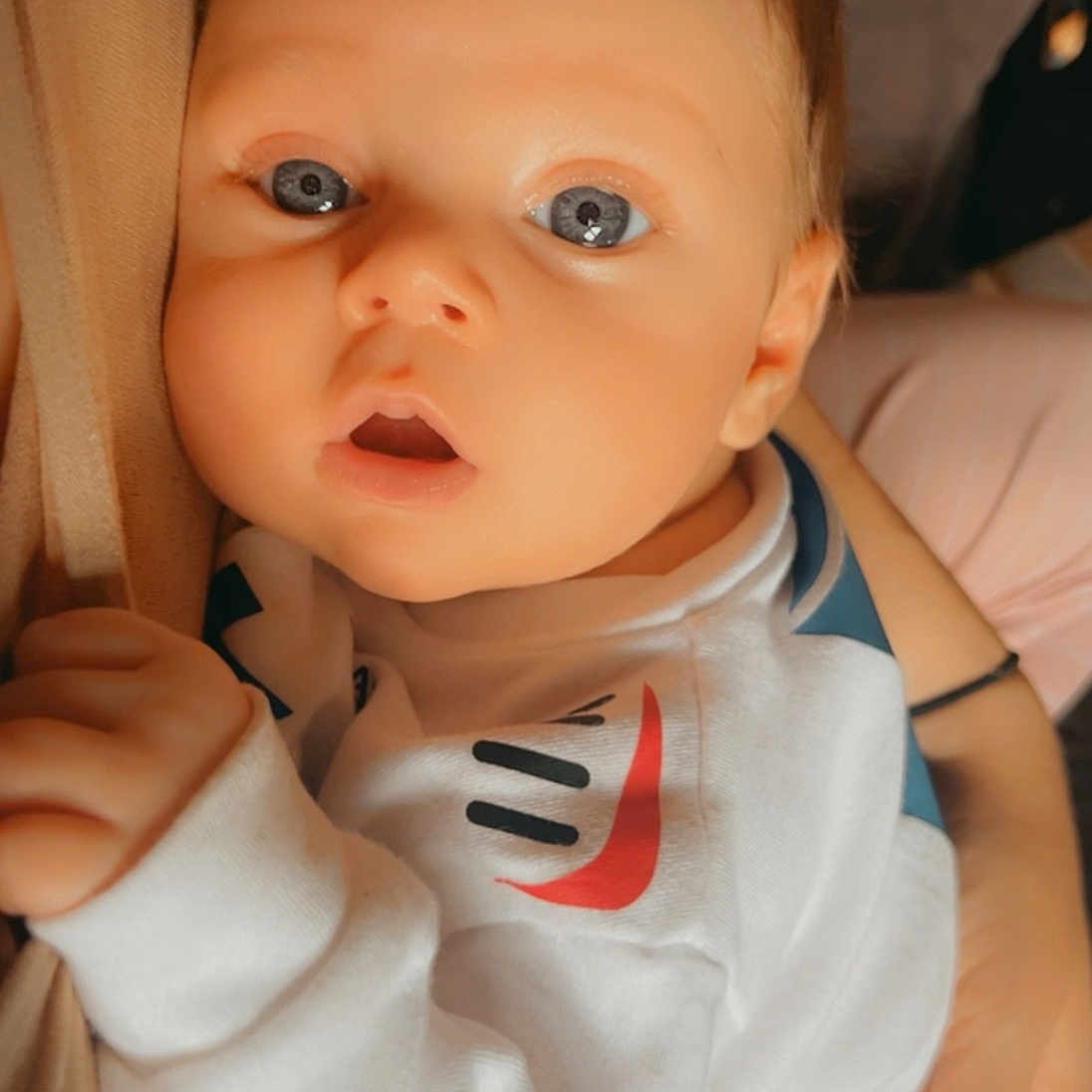 Beckham joined the competition — help win amazing prizes! baby, bodypart, clothing, doll, face, finger, hand, head, hoodie, knitwear, newborn, person, photography, portrait, shirt, sweater, sweatshirt, t_shirt, toy, wrist