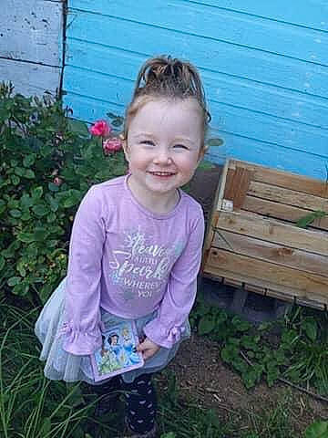 Elayna is registered to the contest to win money with this photo: baby_toddler_clothing, eye, face, flower, fun, garden, grass, hair, happy, head, home_fencing, joy, magenta, pattern, people_in_nature, person, plant, sleeve, smile, t_shirt