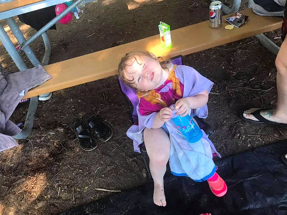 Elayna joined the competition — help win amazing prizes! boot, chair, costume, event, foot, fun, grass, human_leg, lap, leg, leisure, person, recreation, sandal, shoe, shorts, sitting, table, thigh, toddler