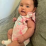 Truly is registered to the contest to win money with this photo: baby, infant, child, pink_clothing, socks, blanket, soft_texture, smiling, cute, skin, face, hand, leg, seated, indoor, portrait, curly_hair, diaper, cozy, happy