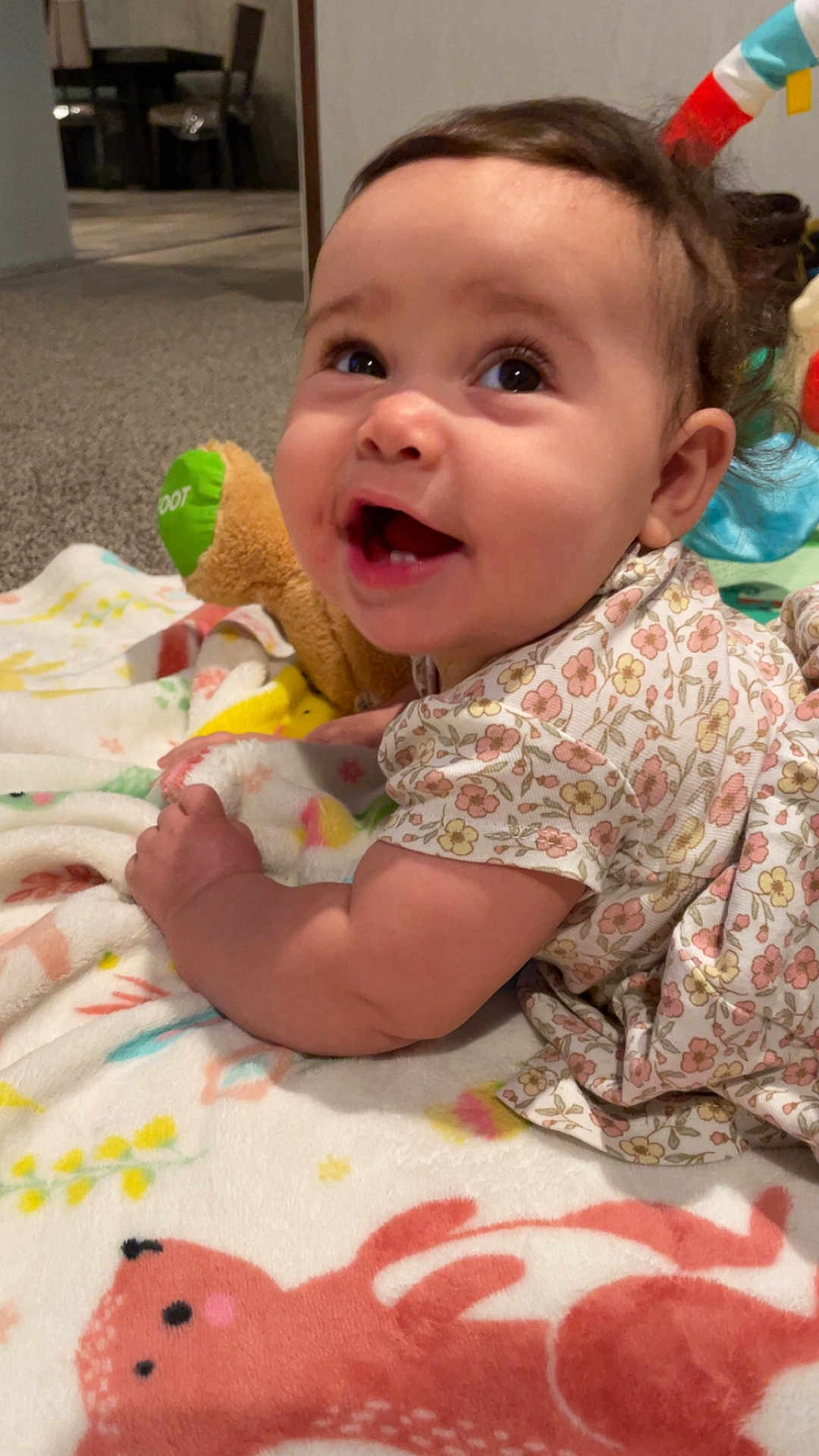 Truly joined the competition — help win amazing prizes! baby, smiling, infant, blanket, toy, indoor, child, cute, happy, face, person, clothing, floral, pattern, soft, carpet, skin, head, toddler, playtime
