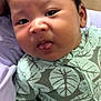 Keano John is registered to the contest to win money with this photo: baby, infant, child, face, tongue, clothing, onesie, hand, skin, hair, portrait, cute, expression, fabric, pattern, leaf, soft, resting, indoors, person