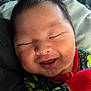 Keano John is registered to the contest to win money with this photo: baby, smiling, face, newborn, child, closeup, cute, infant, happy, apparel, colorful_clothing, sleeping, portrait, skin, head, hair, person, soft_light, indoors, cozy