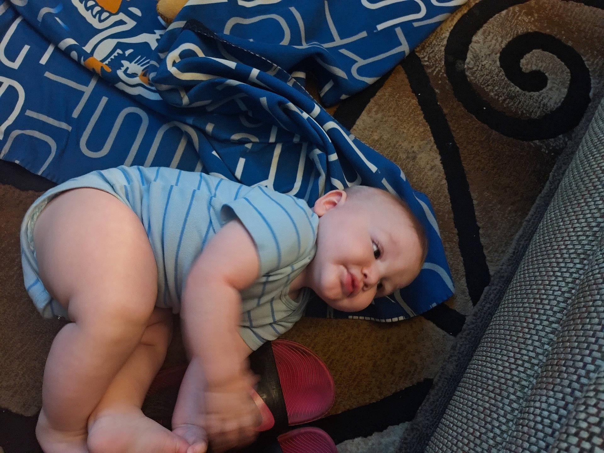 arm, baby, blue_blanket, carpet, child, chubby, crawling, cute, face, floor, foot, hand, head, home, indoor, infant, leg, person, pink_sandals, striped_onesie