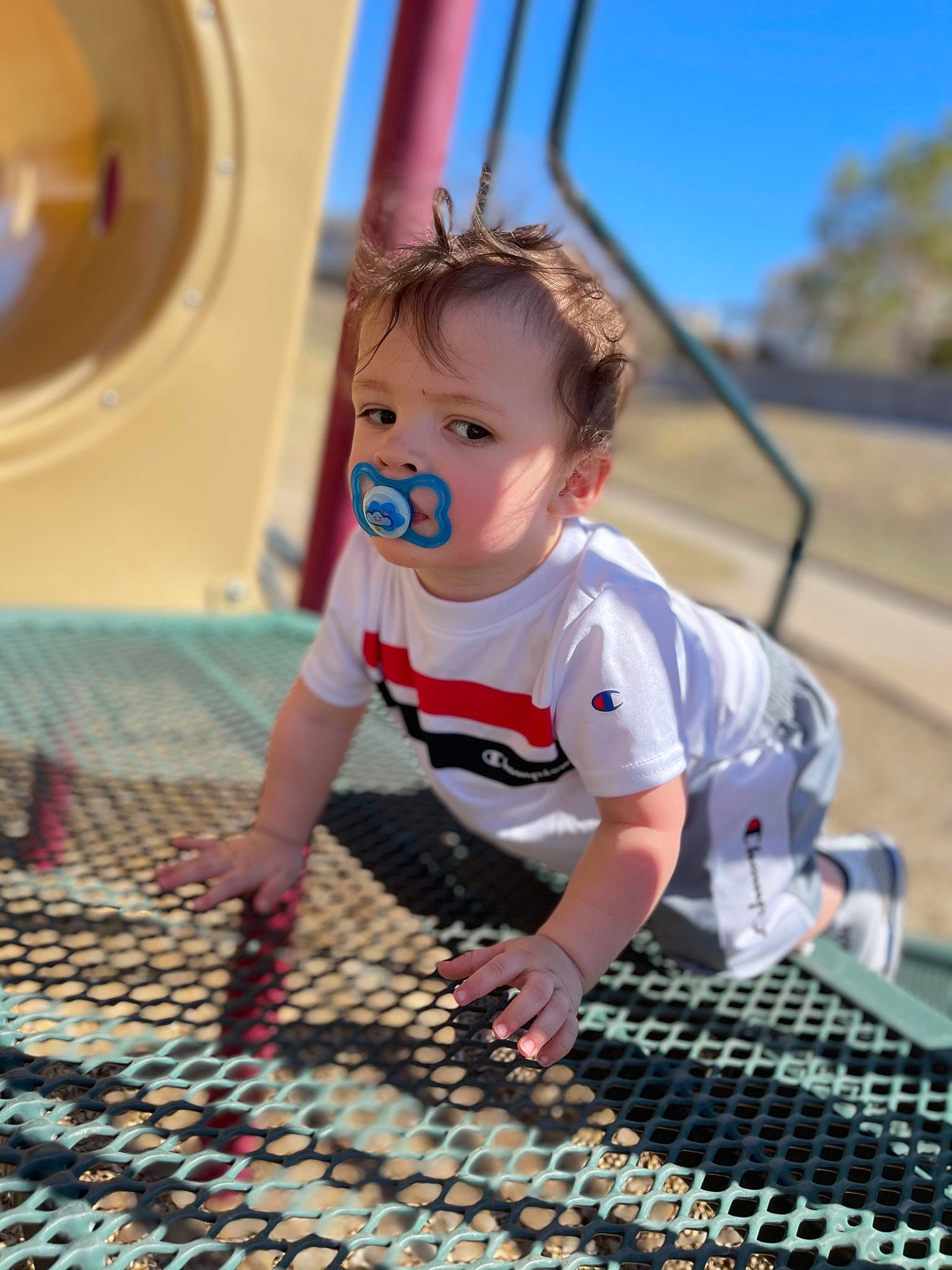 Desmond joined the competition — help win amazing prizes! blue, child, city, electric_blue, flooring, fun, grass, happy, leisure, pattern, person, play, product, recreation, sitting, soil, swing, t_shirt, toddler, vacation