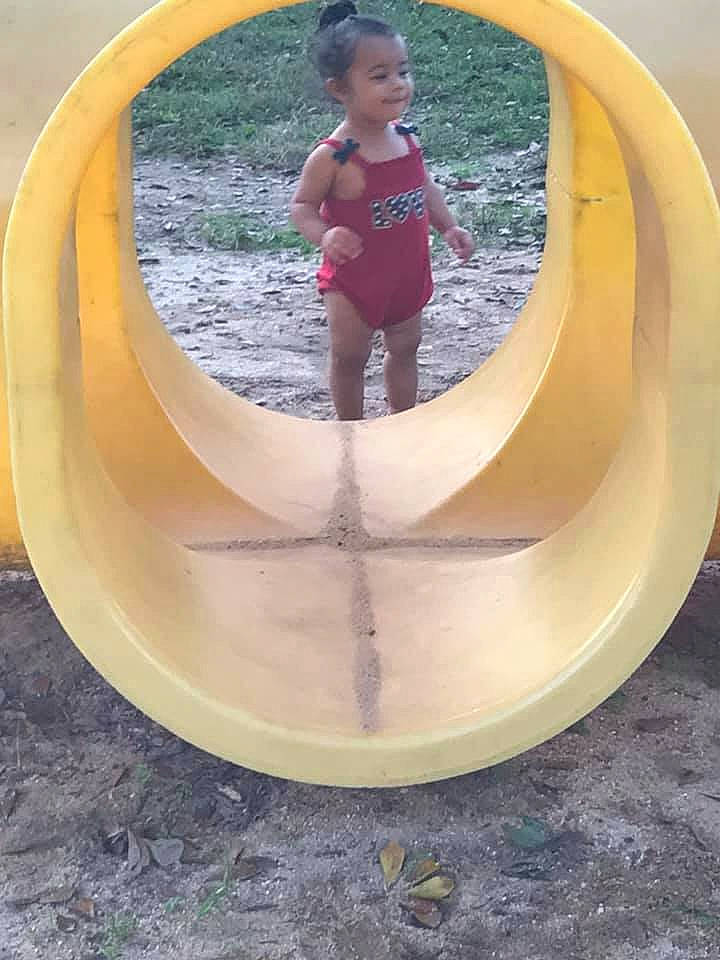 Ka'Leigha joined the competition — help win amazing prizes! art, automotive_wheel_system, chute, circle, font, fun, grass, leisure, outdoor_play_equipment, person, playground, recreation, sculpture, shade, smile, swimwear, toddler, tree, water, window