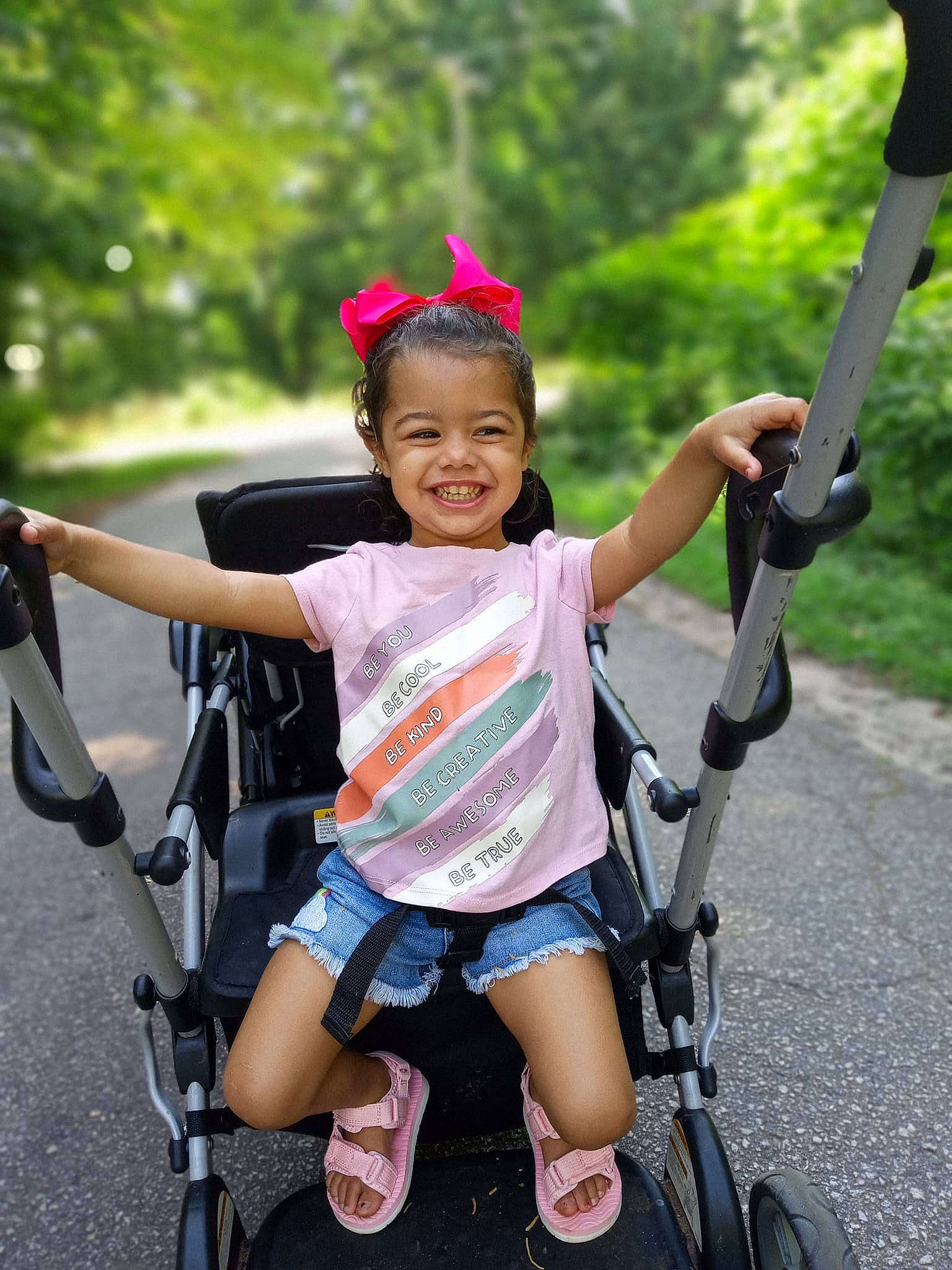 Ka'Leigha joined the competition — help win amazing prizes! baby_carriage, child, facial_expression, fun, grass, happy, joy, leisure, magenta, motor_vehicle, person, photograph, pink, product, recreation, shorts, smile, tire, toddler, travel