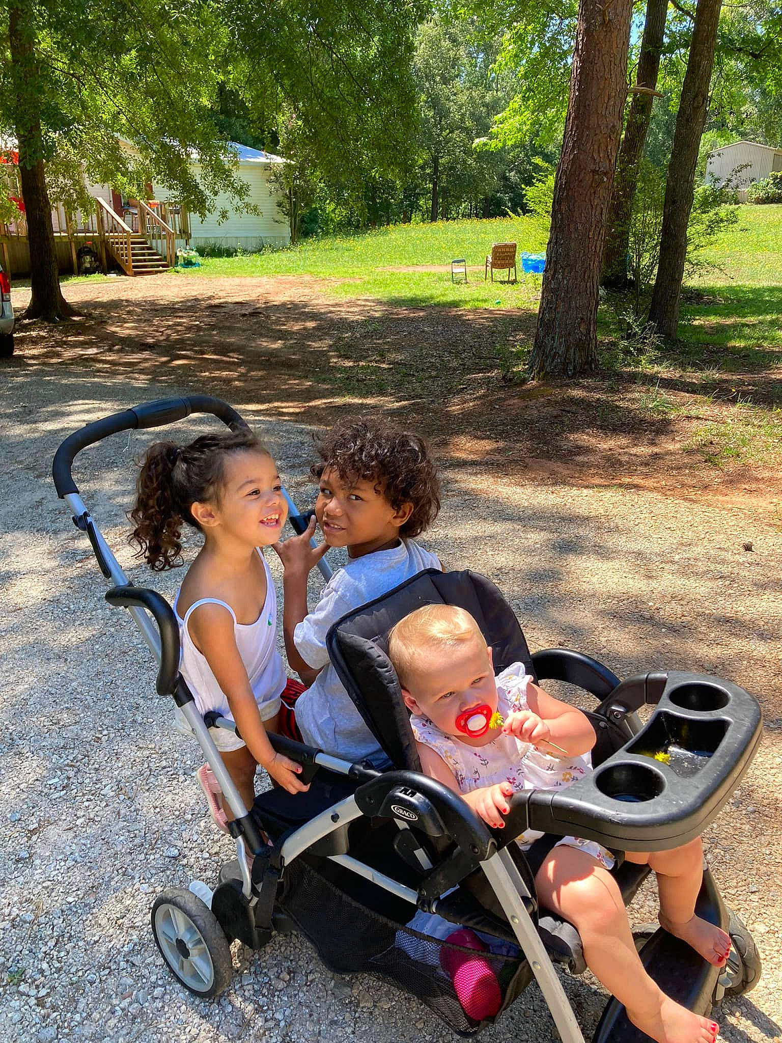 Ka'Leigha is registered to the contest to win money with this photo: baby, baby_carriage, baby_products, child, fun, grass, happy, joy, lap, leisure, people_in_nature, person, plant, recreation, shade, sitting, smile, tire, toddler, travel