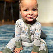 Tamir joined the competition — help win amazing prizes! toddler, child, smile, pajamas, curly_hair, blue_eyes, indoor, rug, hands, feet, sitting, cute, cozy, face, person, infant, home, floor, happy, young_child
