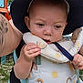 Revan is registered to the contest to win money with this photo: baby, child, hat, outdoor, tattoo, grass, person, closeup, sunlight, colorful, hand, face, blue, nature, vehicle, summer, expression, headwear, vest, daylight