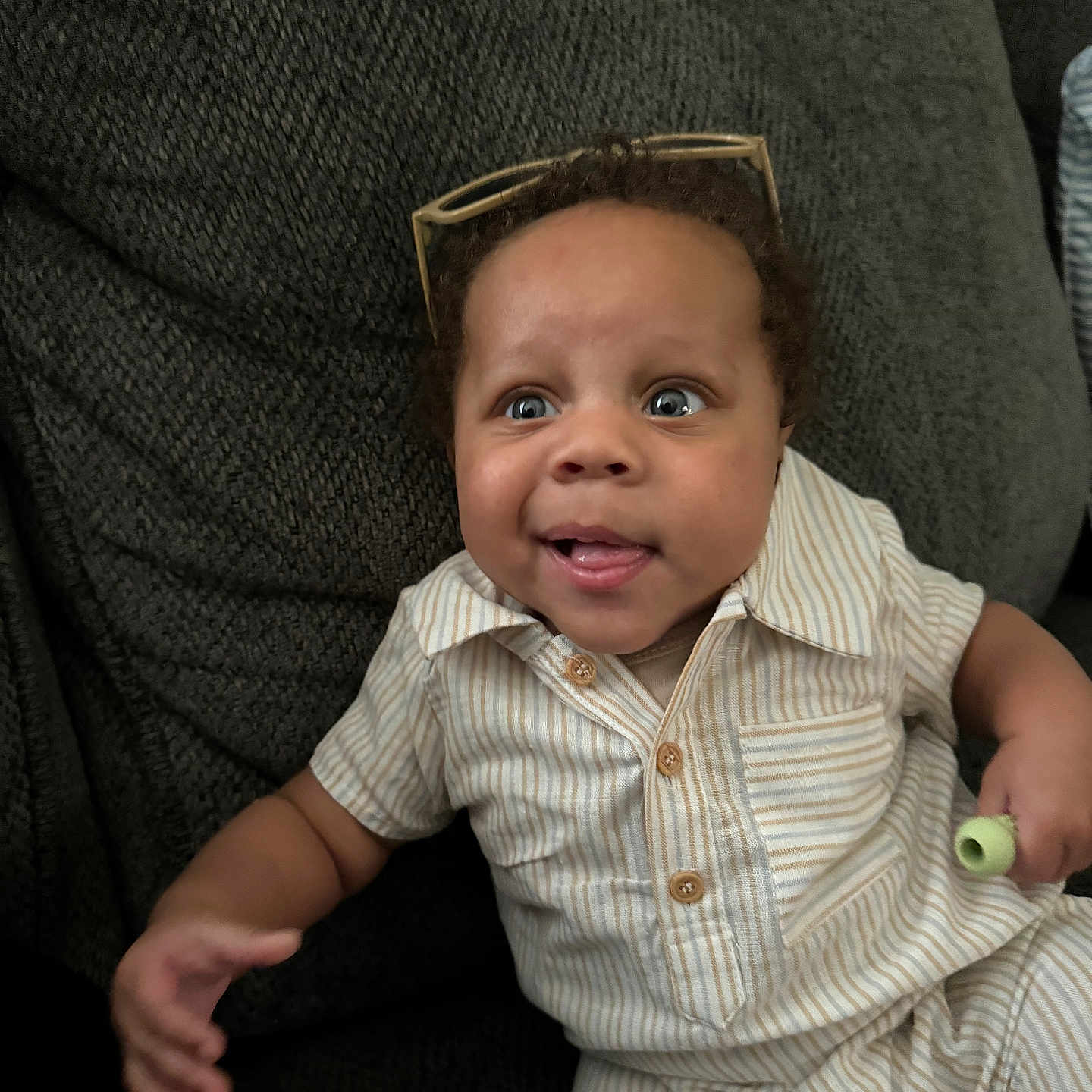 Quade joined the competition — help win amazing prizes! accessories, baby, bodypart, clothing, couch, face, finger, furniture, glasses, hand, happy, hat, head, homedecor, pants, person, photography, portrait, shirt, sitting