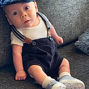 Kodi joined the competition — help win amazing prizes! baby, child, sitting, couch, clothing, cap, suspenders, shoes, socks, indoor, furniture, portrait, cute, infant, face, looking, expression, home, soft, casual