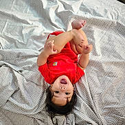 Juliett joined the competition — help win amazing prizes! baby, child, infant, red_shirt, smiling, happy, playing, blanket, patterned_blanket, indoors, cute, face, hands, feet, person, toddler, young_child, skin, hair, joyful