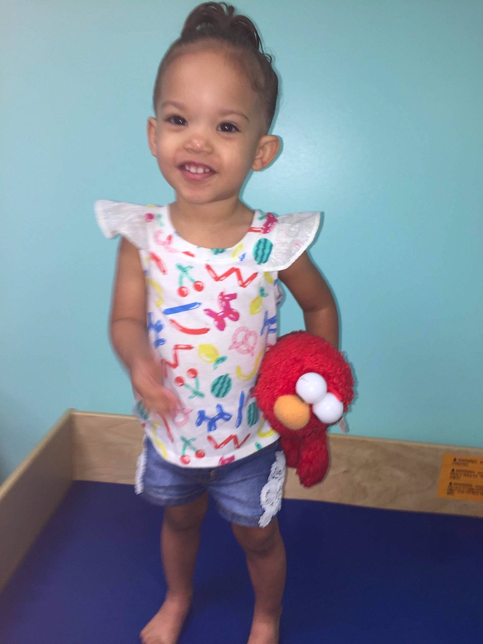 Destiney is registered to the contest to win money with this photo: arm, baby, baby_toddler_clothing, child, fun, joint, joy, neck, pattern, person, play, shorts, shoulder, sleeve, smile, standing, t_shirt, toddler