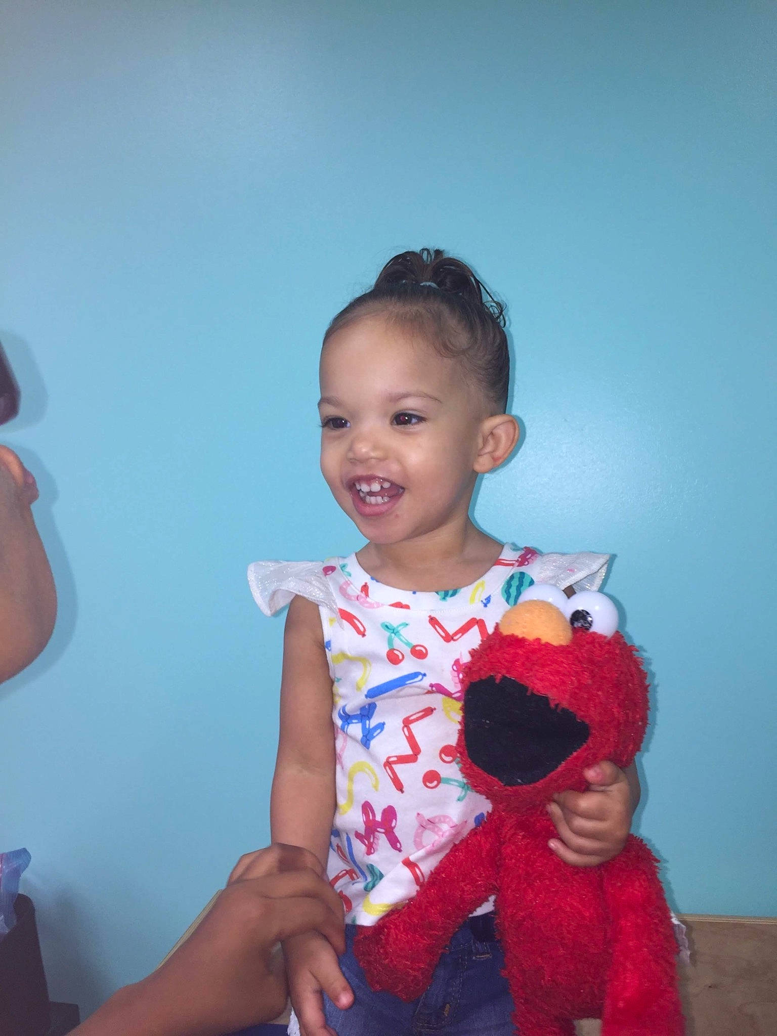Destiney is registered to the contest to win money with this photo: baby, baby_toddler_clothing, child, fun, happy, head, joy, neck, people, person, play, room, sitting, skin, smile, standing, stuffed_toy, t_shirt, textile, toddler
