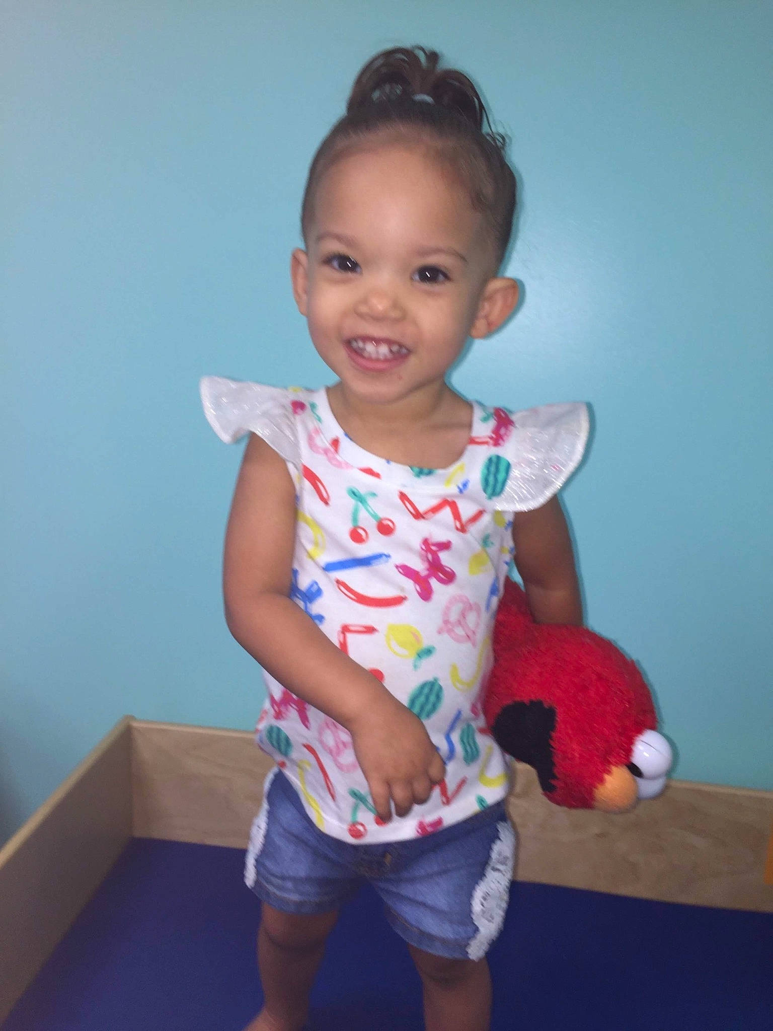 Destiney is registered to the contest to win money with this photo: arm, baby, baby_toddler_clothing, cheek, child, face, head, joint, joy, neck, person, pink, play, shoulder, skin, sleeve, smile, standing, t_shirt, toddler