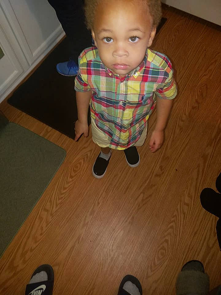 Jabari is registered to the contest to win money with this photo: cheek, child, design, finger, floor, flooring, hardwood, head, pattern, person, plaid, play, skin, standing, toddler, wood