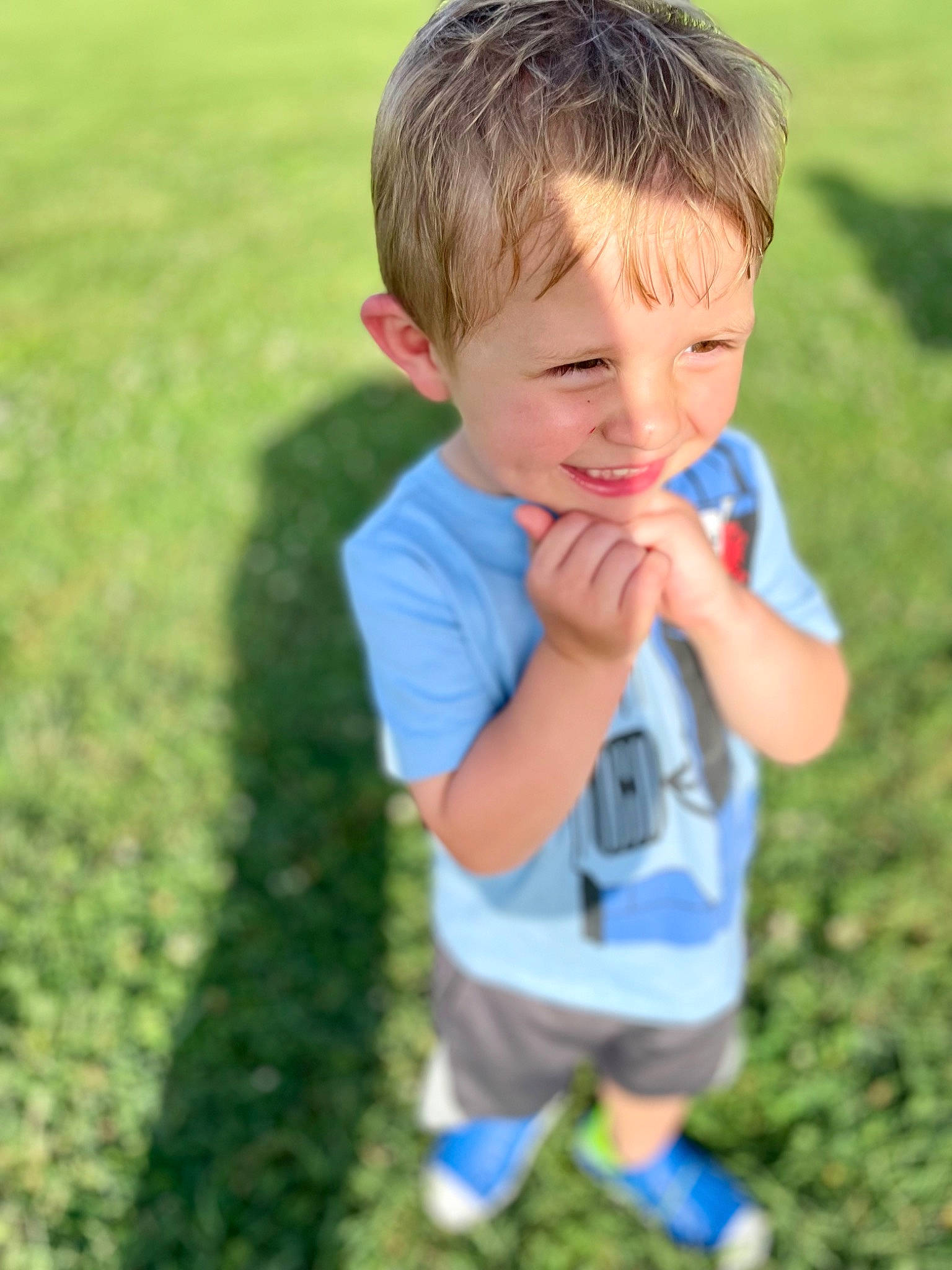 Kainen is registered to the contest to win money with this photo: baby_toddler_clothing, child, cool, finger, fun, gesture, grass, grass_family, grassland, happy, joy, lawn, leisure, meadow, nose, people_in_nature, person, sleeve, smile, standing