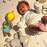 Kyuss is registered to the contest to win money with this photo: baby, infant, smiling, lying_down, toy, elephant_toy, stuffed_animal, quilt, blanket, happy, child, cute, soft_toys, playful, indoor, newborn, two_months, foot, clothing, patterned