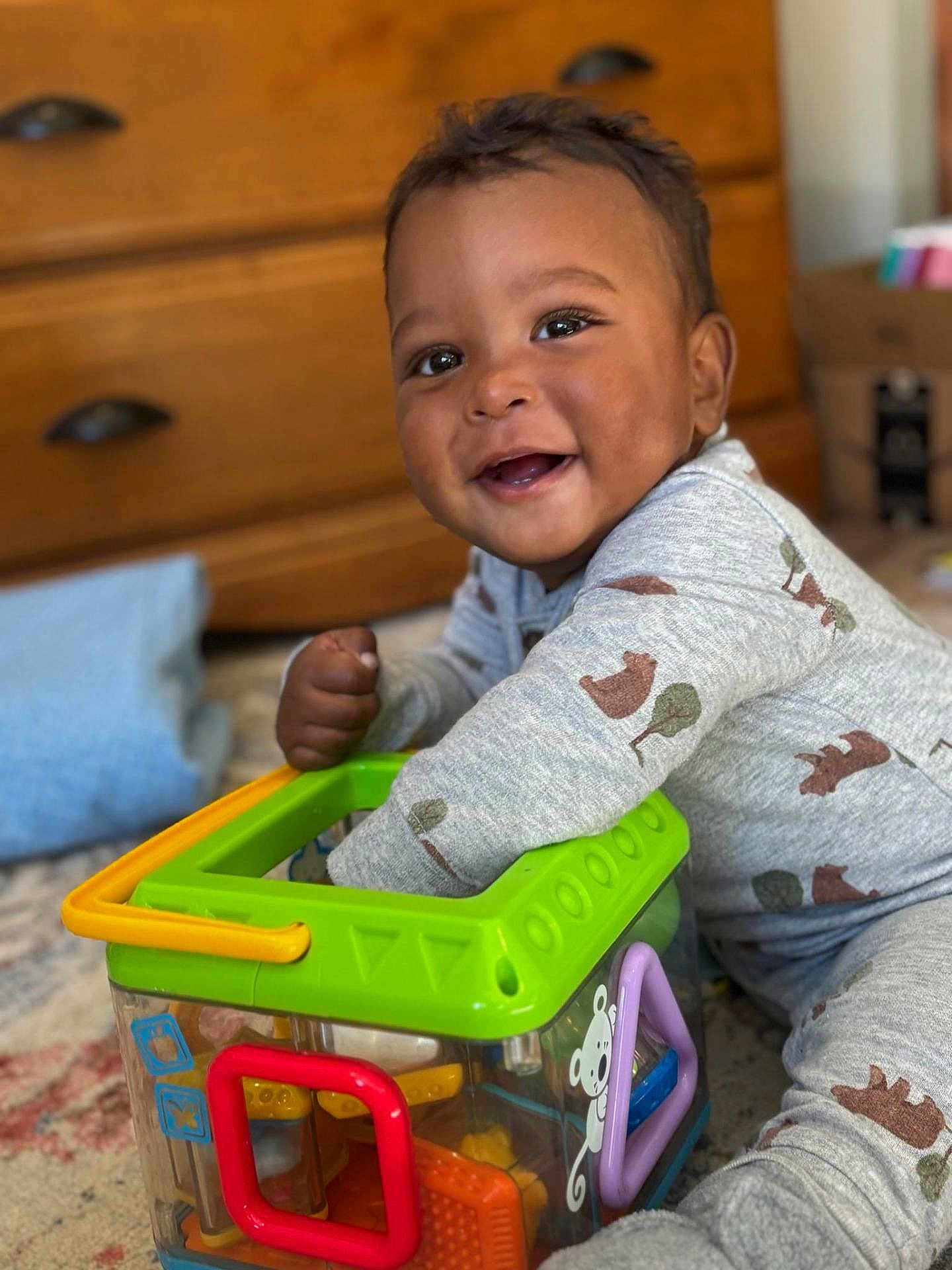 Raizo joined the competition — help win amazing prizes! toddler, child, smiling, toy, pajamas, indoors, playing, colorful, cube, furniture, carpet, face, happy, person, cute, home, wood, drawer, pillow, floor